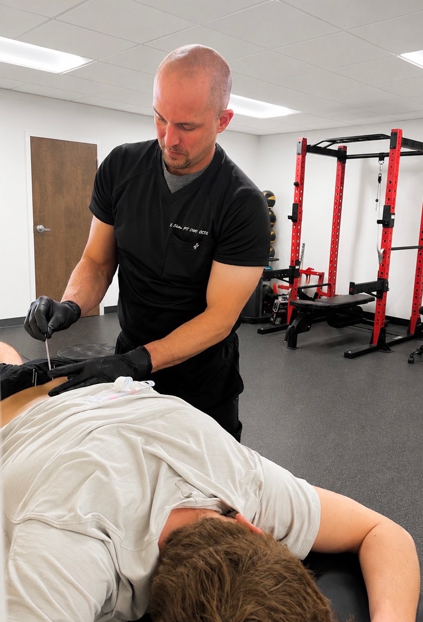 Dr. Eric Schmitt performing dry needling treatment at Hat City Physical Therapy, Danbury CT